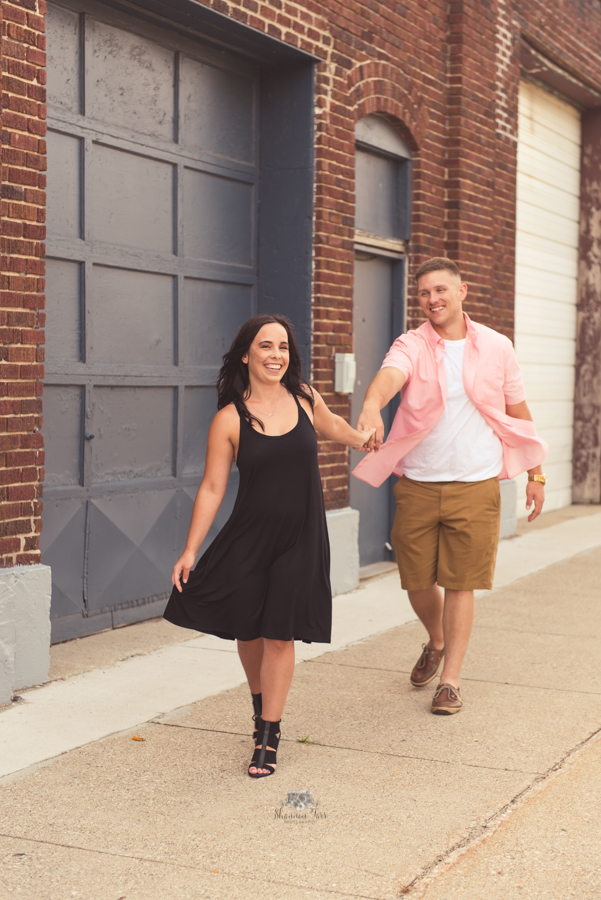 Engagement Photography in Ludington MI of couple walking downtown