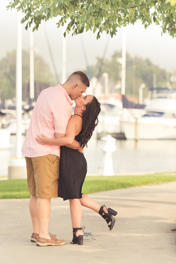 Engagement Photography in Ludington MI of couple standing in path kissing