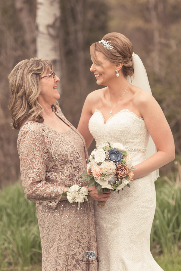 Mother looking at bride laughing