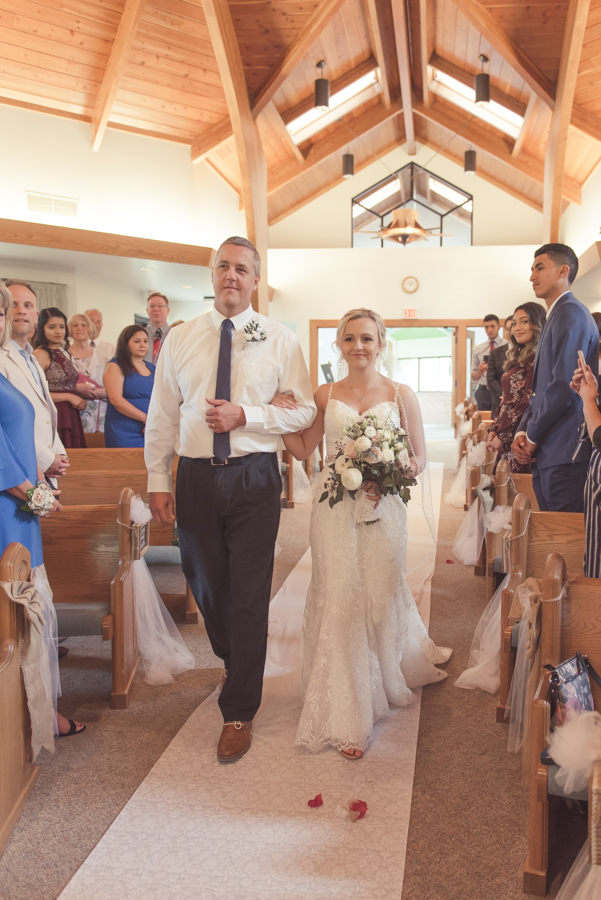 bride walking down aisle at Vos Chapel