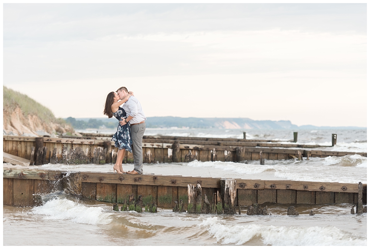 couple kissing on pier in Ludington