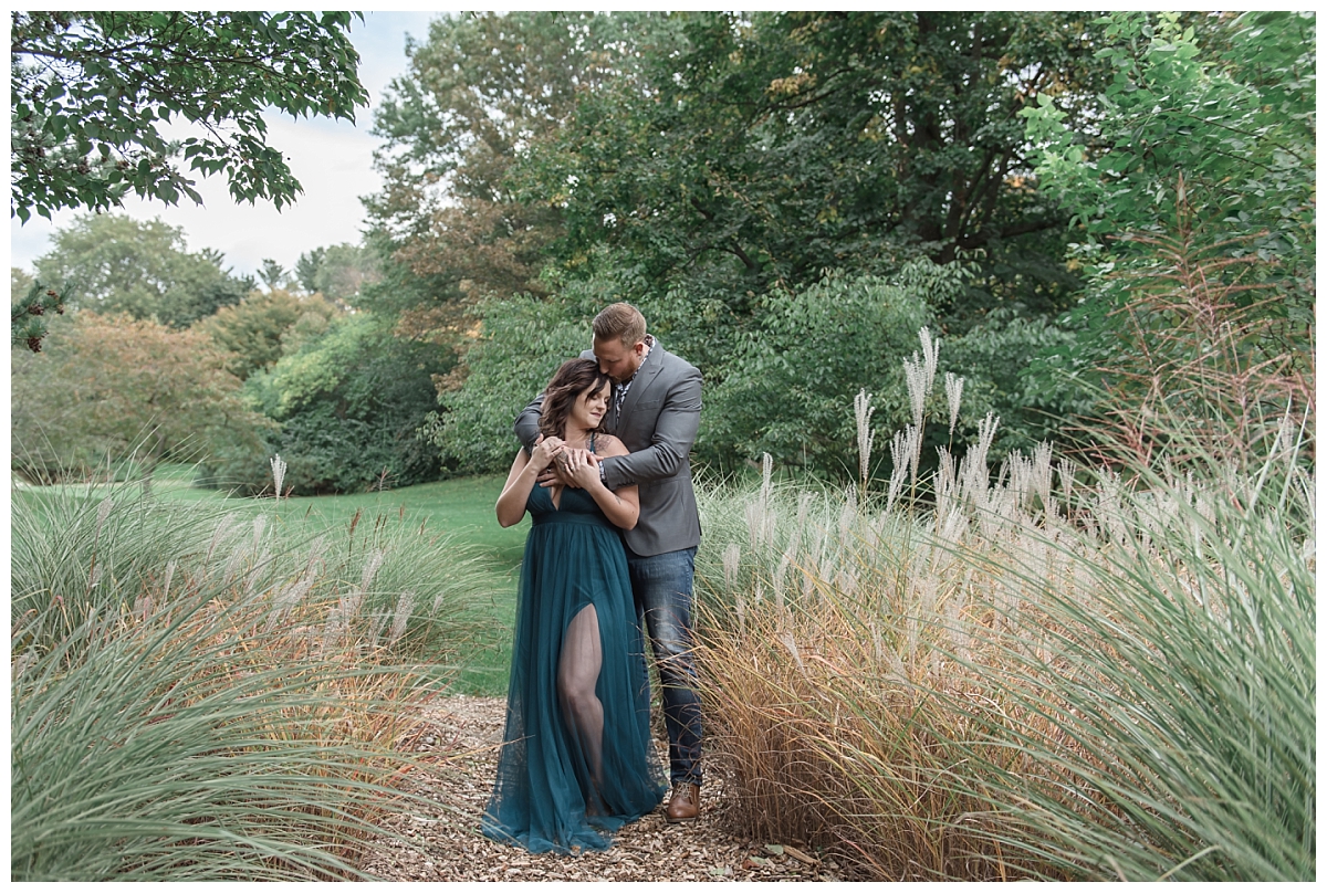 couple holding each other in tall grass