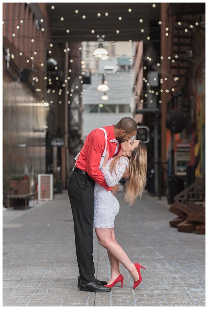 couple standing in alley kissing