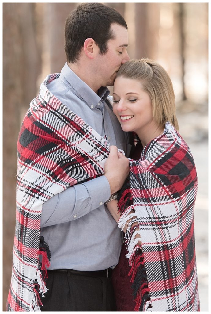 couple wrapped in blanket holding each other